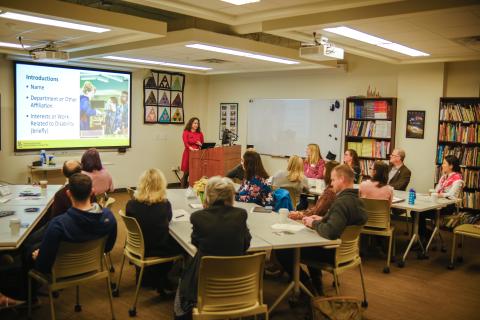 a photo of kristen padilla speaking to a group of adults in a classroom