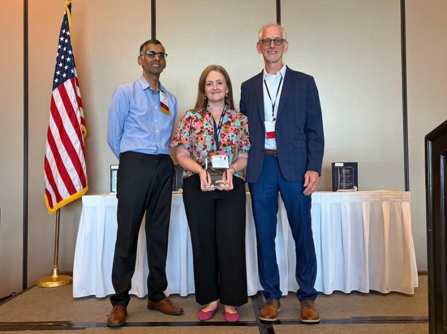 Photo of Sarah Mire Accepting Award