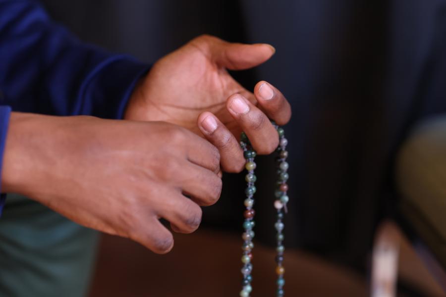 Hands holding prayer beads.