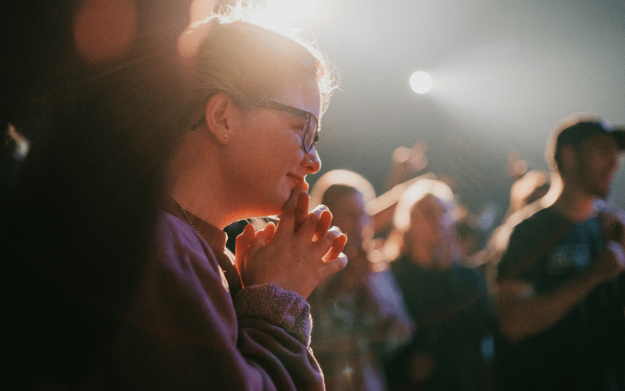 Stock Photo Illustration of woman with glasses worshipping (Credit: Vince Fleming/Unsplash/https://tinyurl.com/35whmwpk)