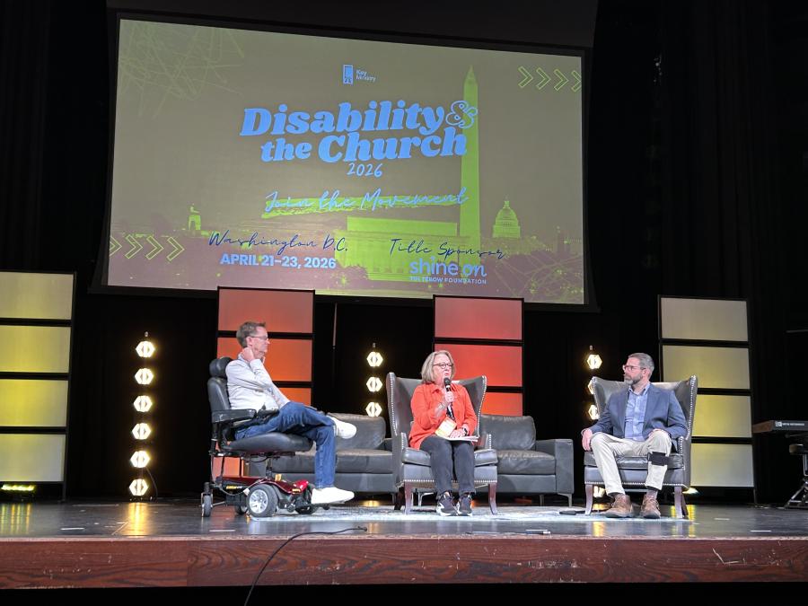 Photo of Jason Le Shana in a panel discussion on the main stage of the DATC conference.
