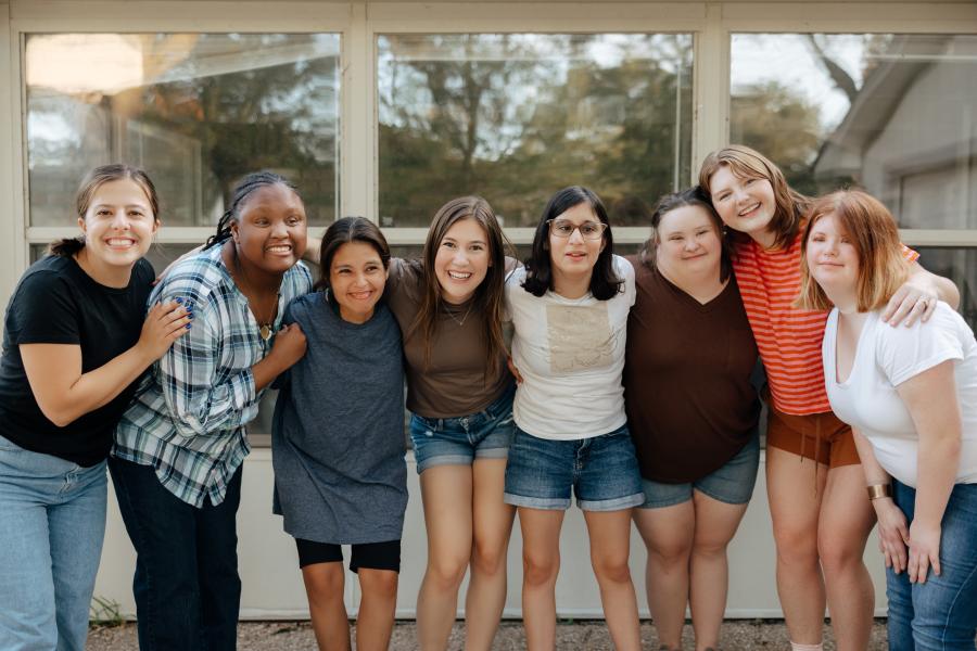 Photo of smiling young adult friends with and without disabilities.