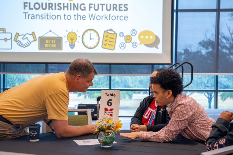 Photo of BCDF executive director conversing with student at Oso Able conference.